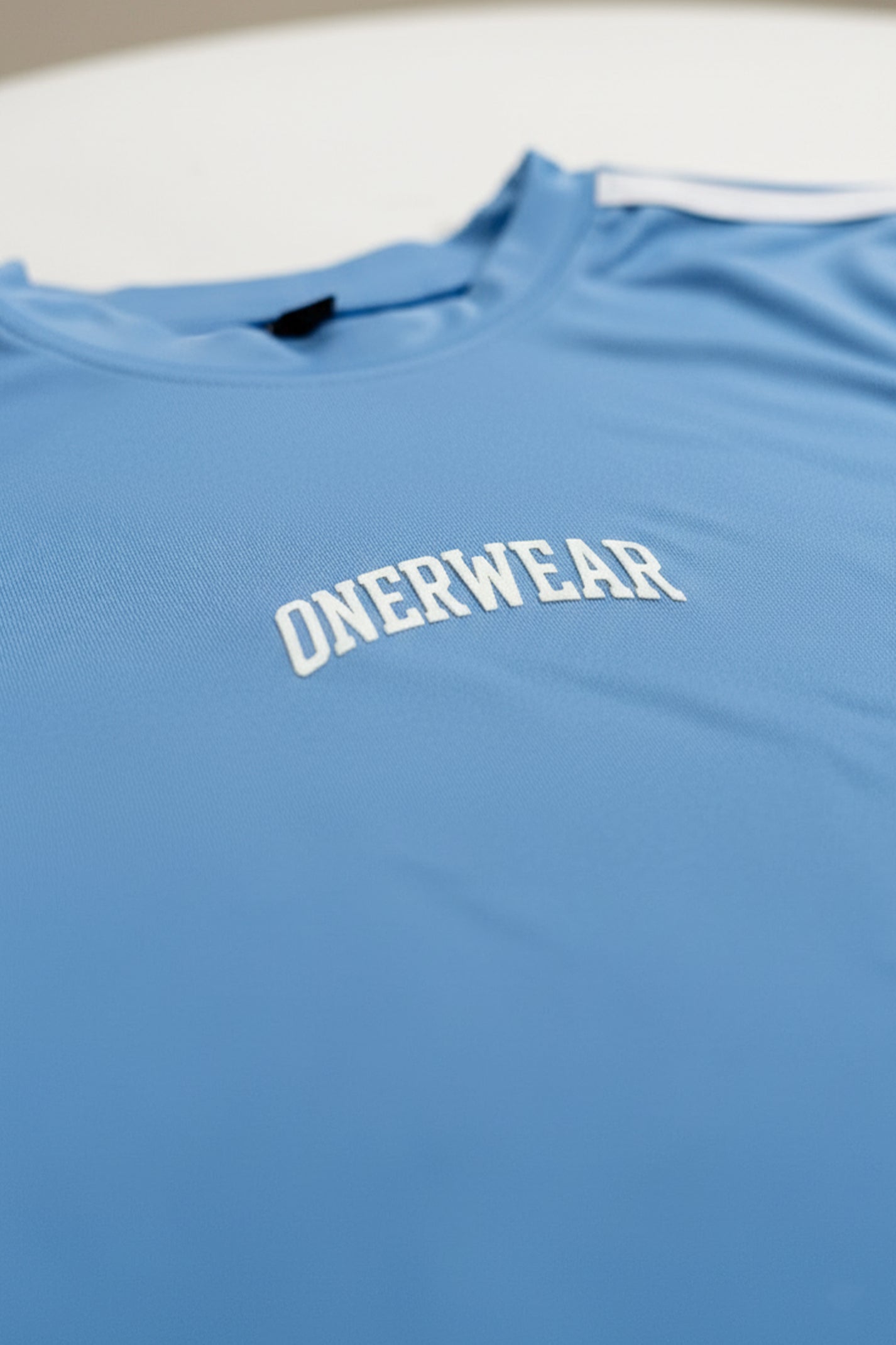 Blue shirt with 'ONERWEAR' logo on a white background