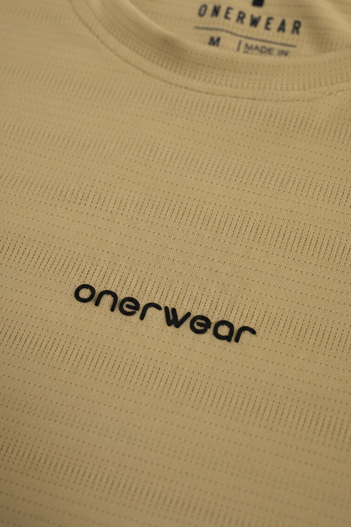 Close-up of beige fabric with 'onerwear' logo and text.