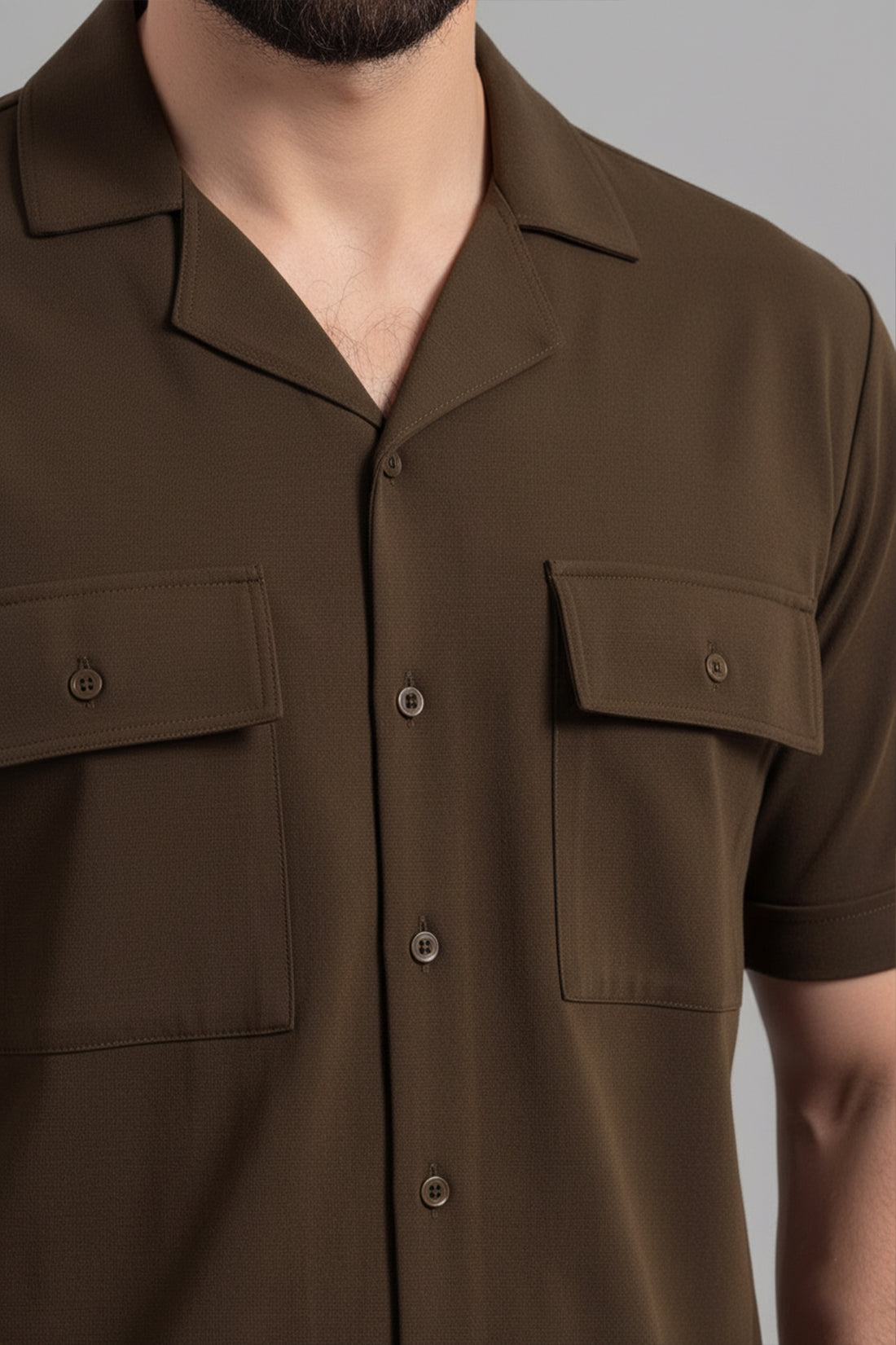 Brown short-sleeve shirt with pockets on a gray background