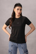 Woman wearing a black t-shirt with text on a gray background
