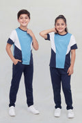 Two children wearing matching blue and navy outfits on a plain background