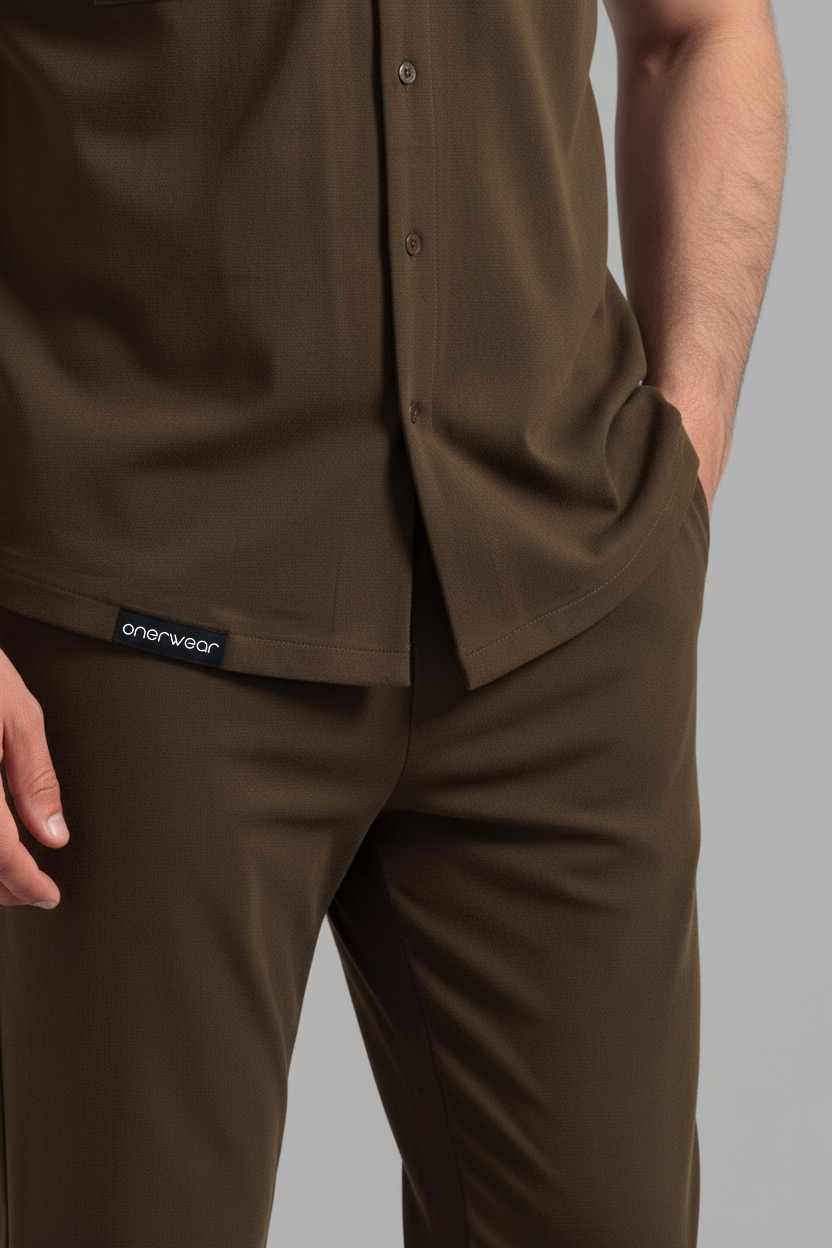 Brown shirt and pants with a visible brand label on a gray background