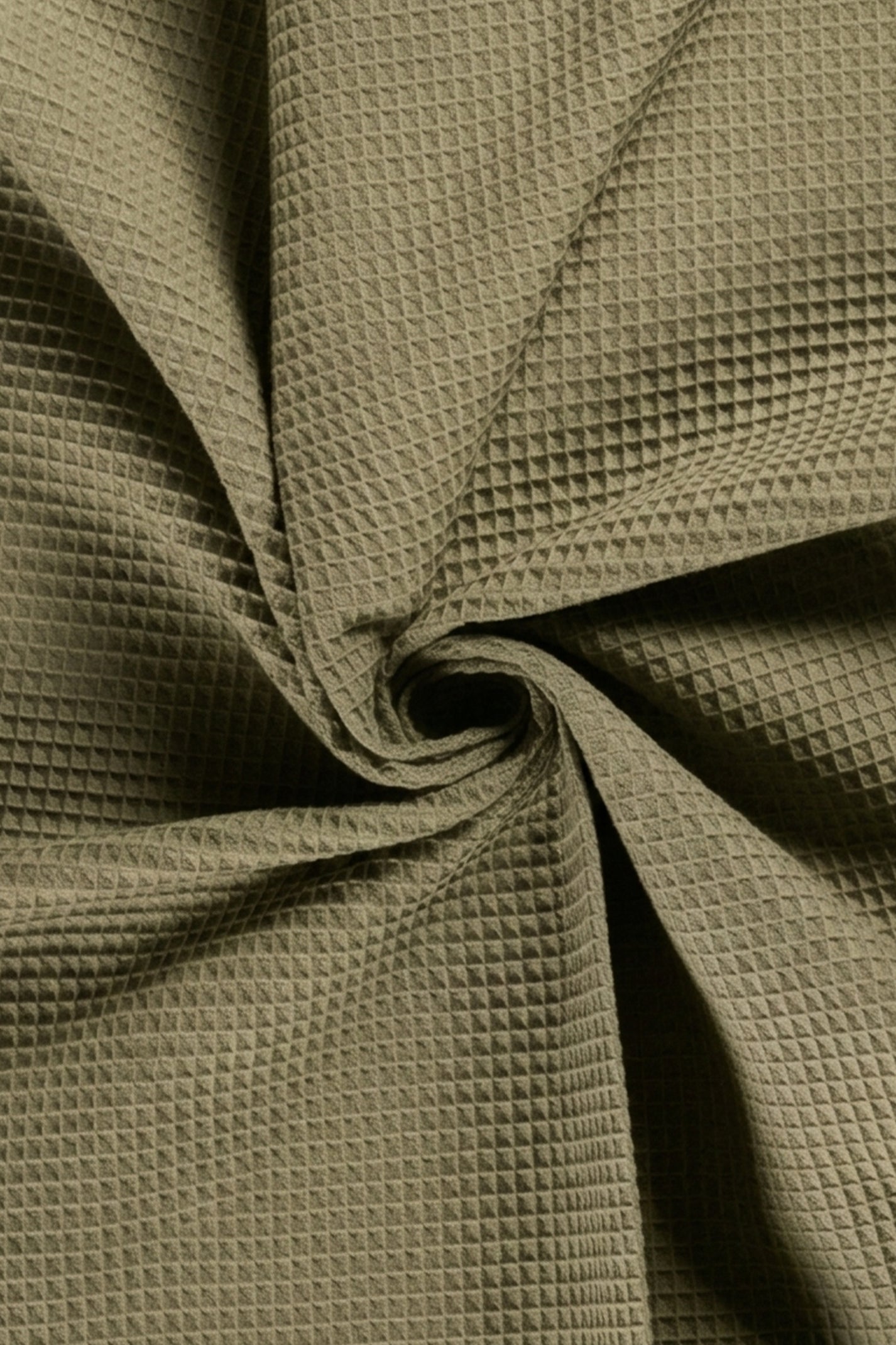 Close-up of textured green fabric with a crumpled appearance