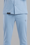 Light blue shirt and pants set with brand labels on a gray background