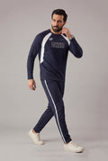 Man wearing a navy tracksuit with 'ONER' branding on a gray background