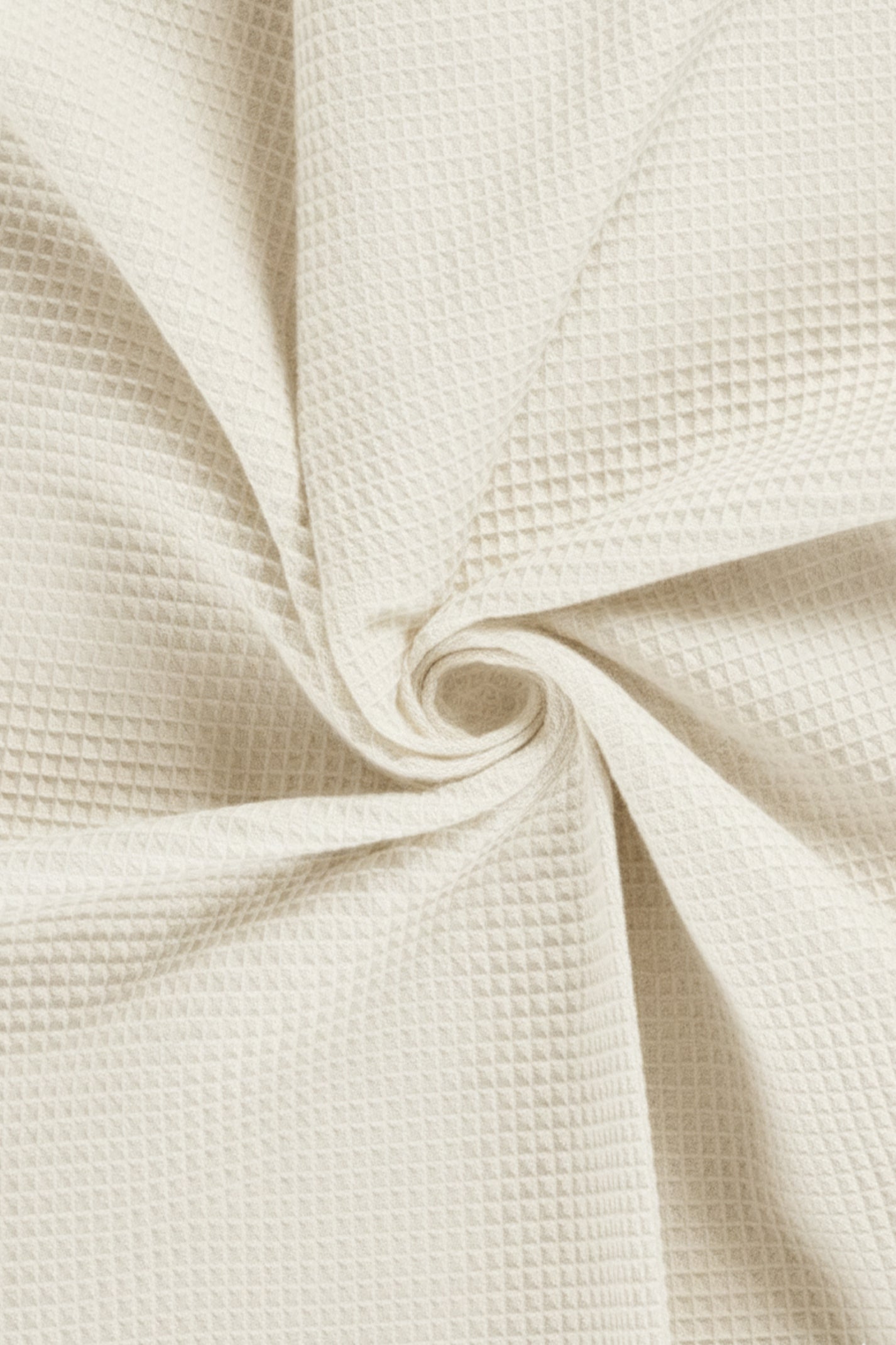 Close-up of beige textured fabric with a swirl pattern