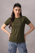 Woman wearing an olive green t-shirt with text on a gray background