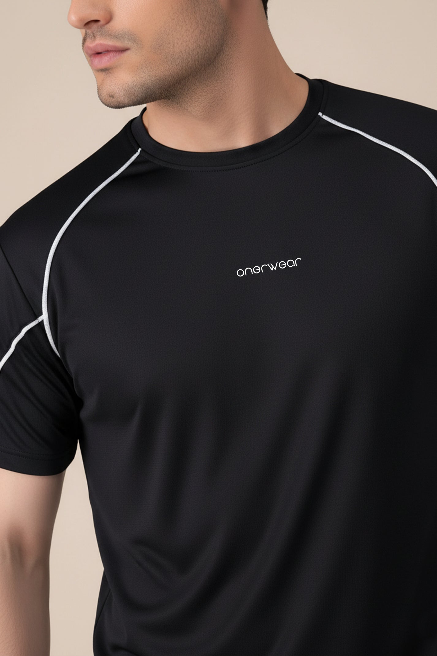 Black athletic shirt with 'onerwear' logo on a beige background