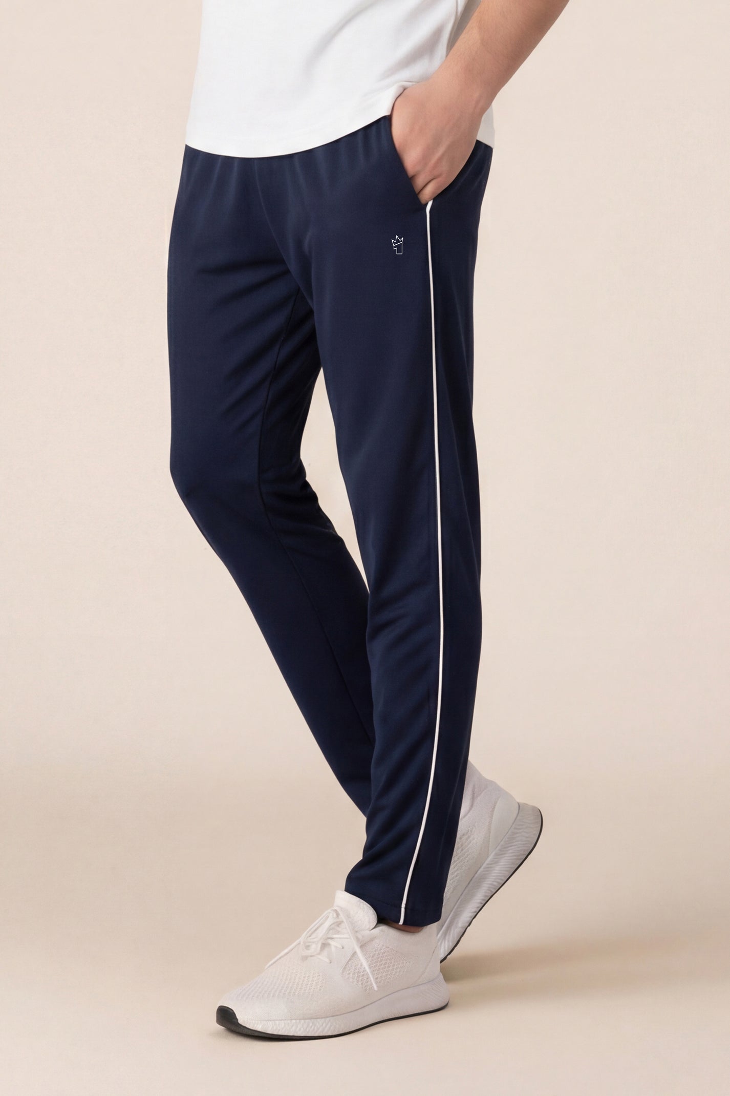 Person wearing navy pants with a white stripe on a beige background