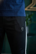 Black pants with a white logo on a dark background