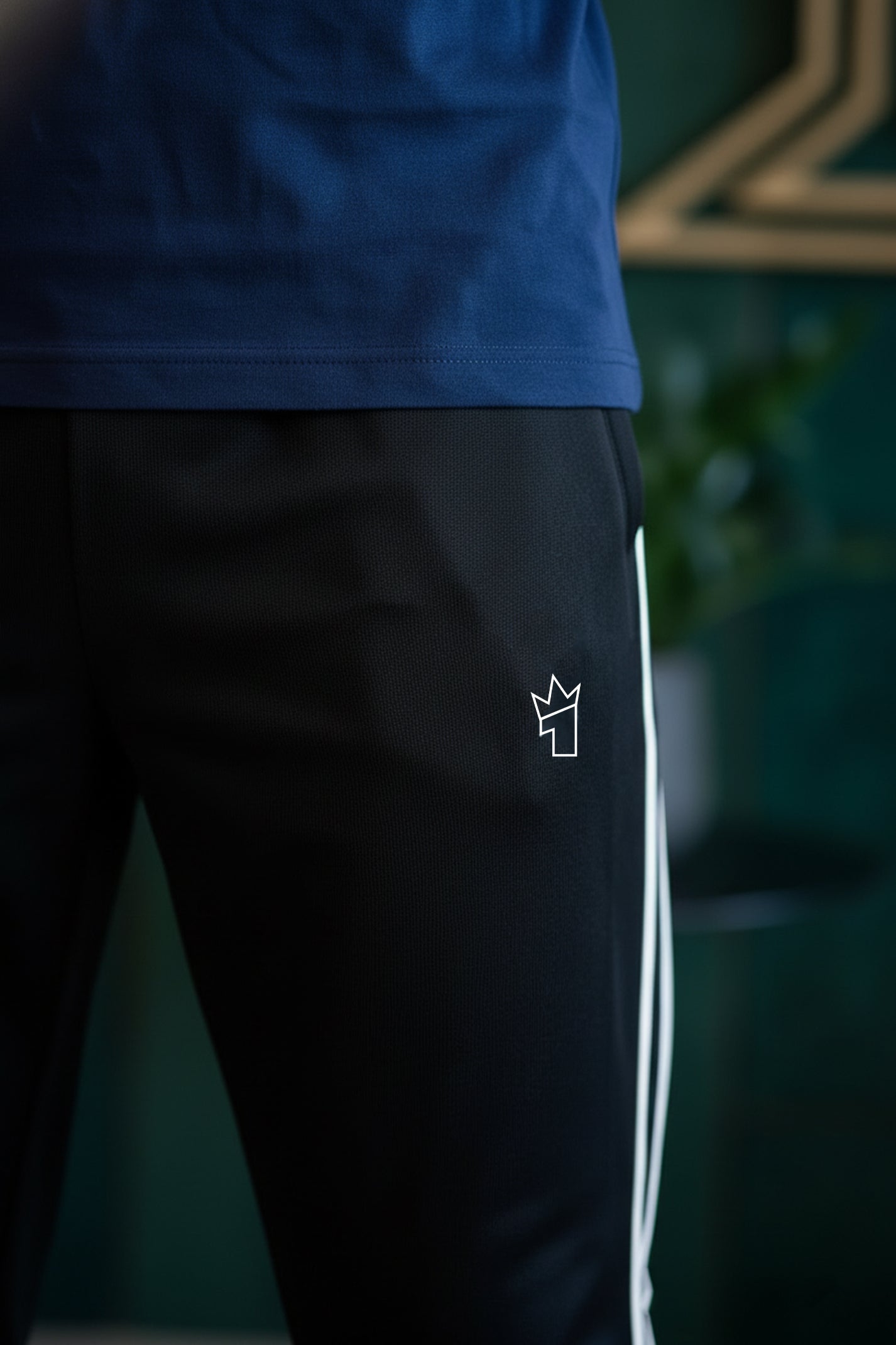 Black pants with a white logo on a dark background